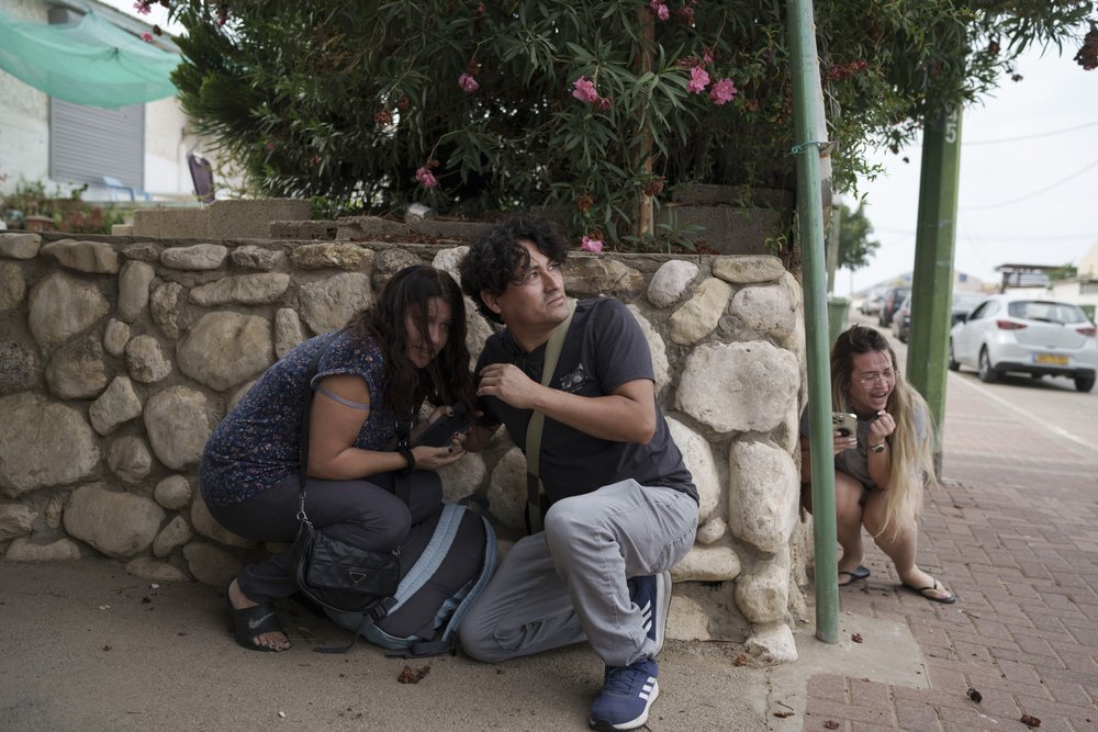  Israelis take cover from the incoming rocket fire from the Gaza Strip in Ashkelon, southern Israel, Wednesday, Oct. 11, 2023. Photo by Leo Correa 