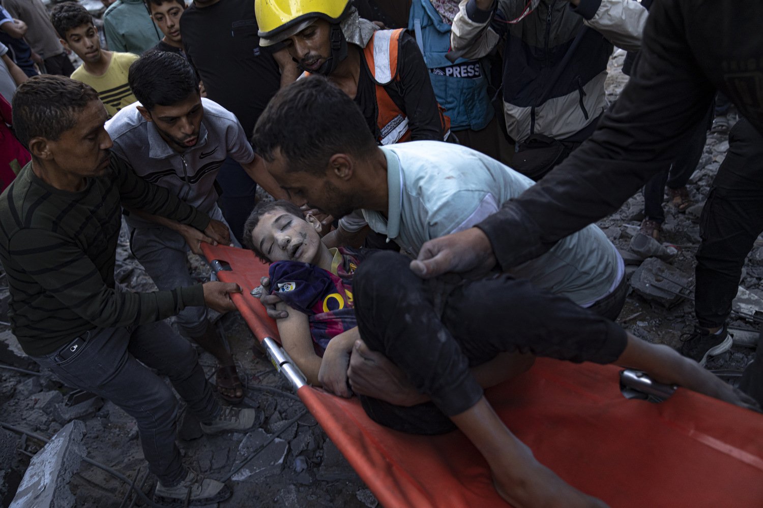  Palestinians evacuate wounded boy from a building destroyed in Israeli bombardment in Khan Younis, Gaza Strip, Thursday, Oct. 19, 2023. Photo by Fatima Shbair 