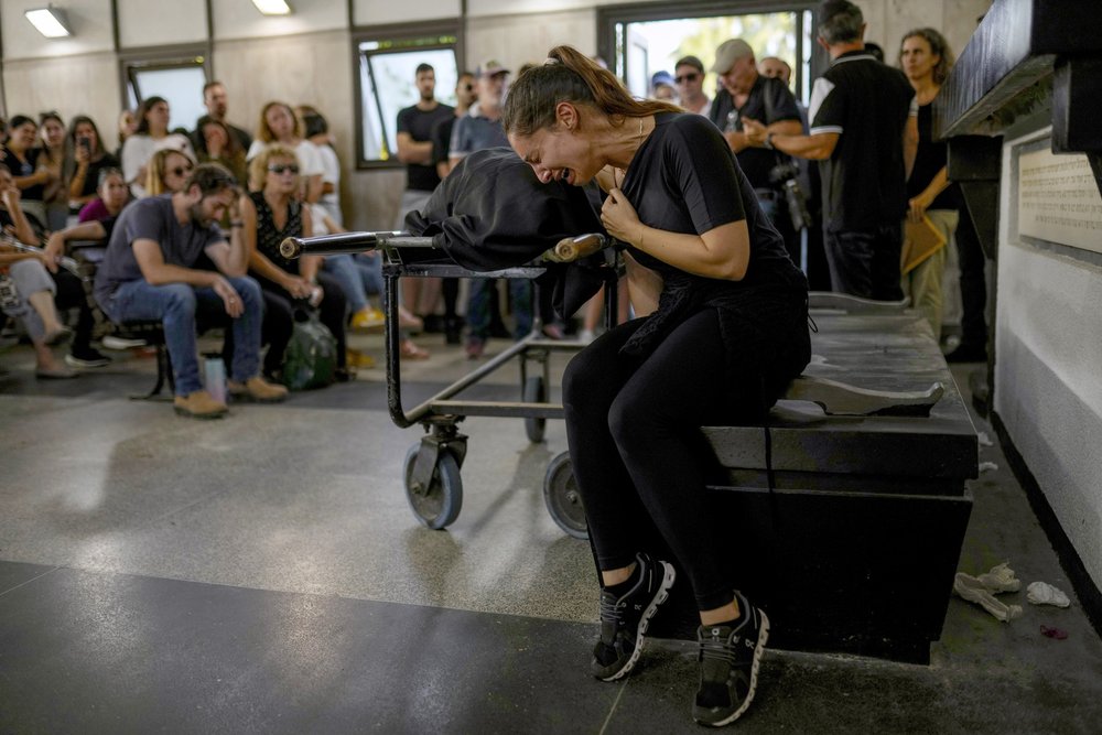  Mourners react beside the body of Mapal Adam, during her funeral in Tel Aviv, Israel, Wednesday, Oct. 11, 2023. Adam was killed by Hamas militants on Saturday as they carried out an unprecedented, multi-front attack that killed over 1,000 Israelis. 