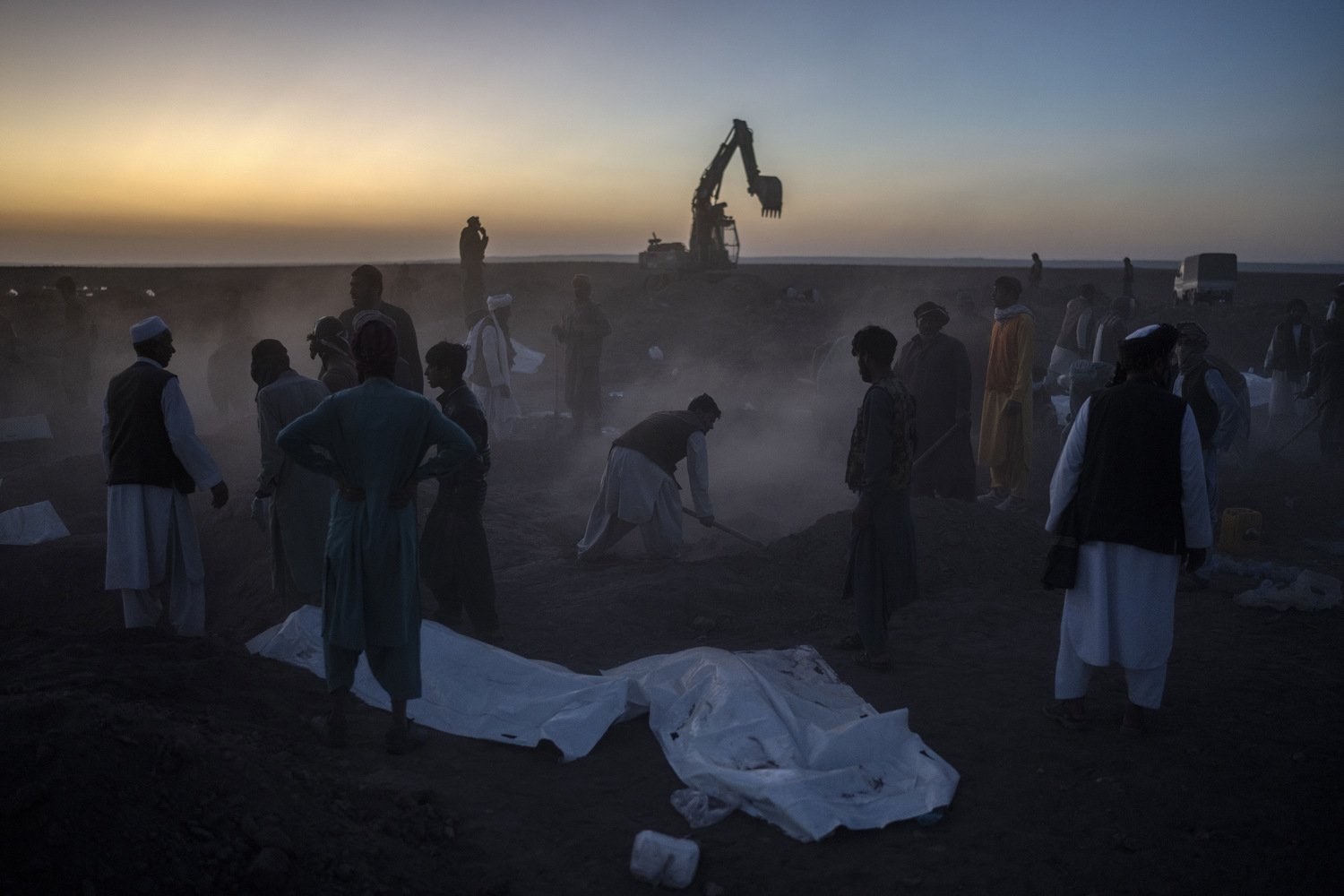   Afghans bury hundreds of people killed in an earthquake at a burial site, outside a village in Zenda Jan district in Herat province, western of Afghanistan, Monday, Oct. 9, 2023. Saturday's deadly earthquake killed and injured thousands when it lev