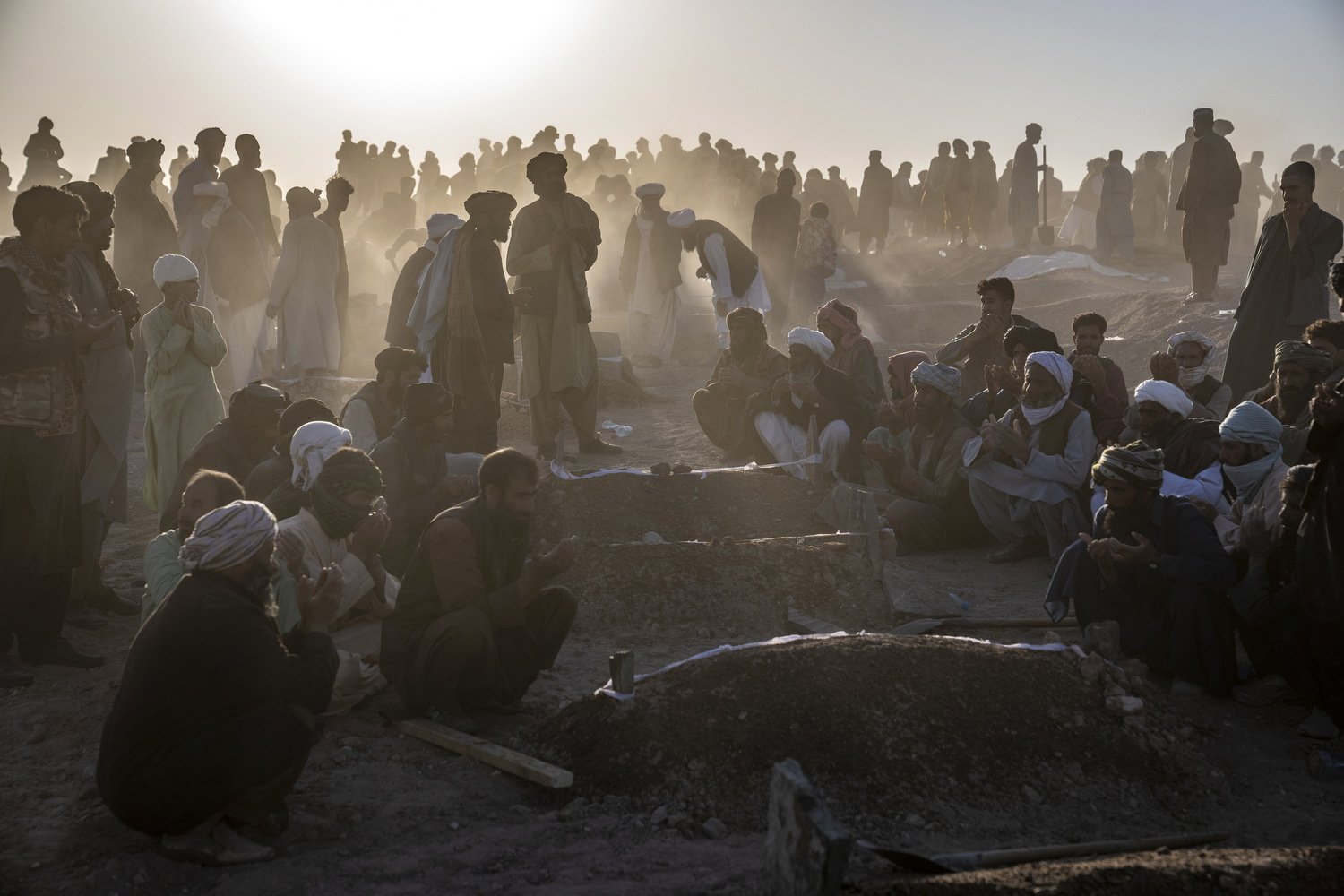  Afghans bury hundreds of people killed in an earthquake to a burial site, in a village in Zenda Jan district in Herat province, western of Afghanistan, Monday, Oct. 9, 2023. Saturday's deadly earthquake killed and injured thousands when it leveled a