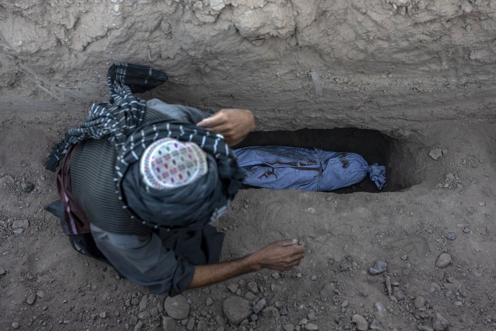  An Afghan man buries his little grandson who was killed by the earthquake, in Zenda Jan district in Herat province, western of Afghanistan, Monday, Oct. 9, 2023. Saturday's deadly earthquake killed and injured thousands when it leveled an untold num