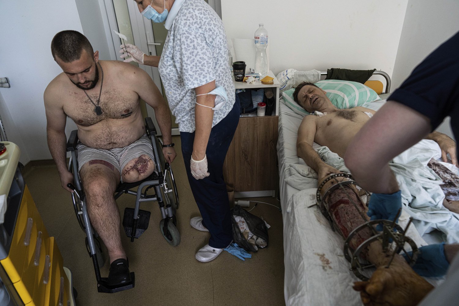  Medics bandage the wound of a Ukrainian serviceman at St. Panteleimon hospital in Lviv, Ukraine, Tuesday, July 25, 2023. At a rehabilitation hospital in the western city of Lviv, soldiers rely as much on each other as they do upon the physicians and
