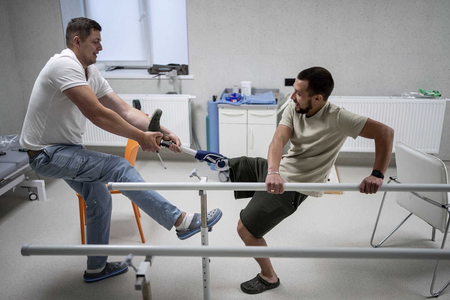  Dmytro Kononchuk, left, a prosthetist, tests Ruslan's prosthesis at the Superhumans rehabilitation center in Vynnyky, Ukraine, Thursday, July 20, 2023. Ukraine is facing the prospect of a future with upwards of 20,000 amputees, many of them soldiers