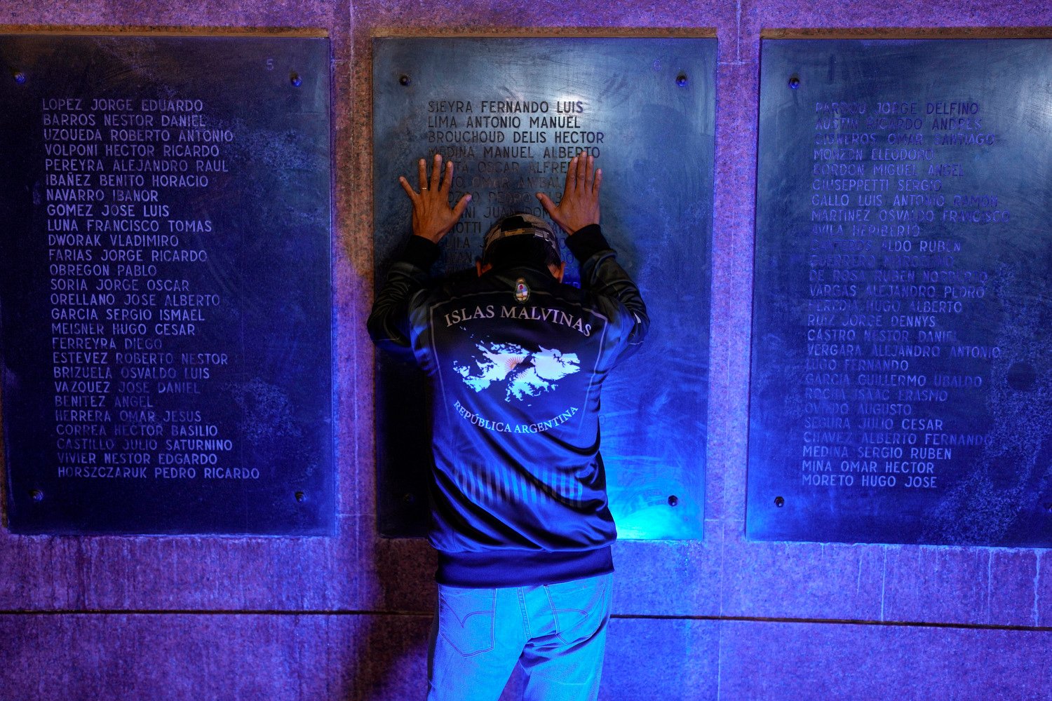  A man places his hands on a war memorial during a ceremony marking the 42nd anniversary of the conflict between Argentina and Great Britain over the Falkland Islands or Malvinas Islands in Buenos Aires, Argentina, April 1, 2024. (AP Photo/Natacha Pi