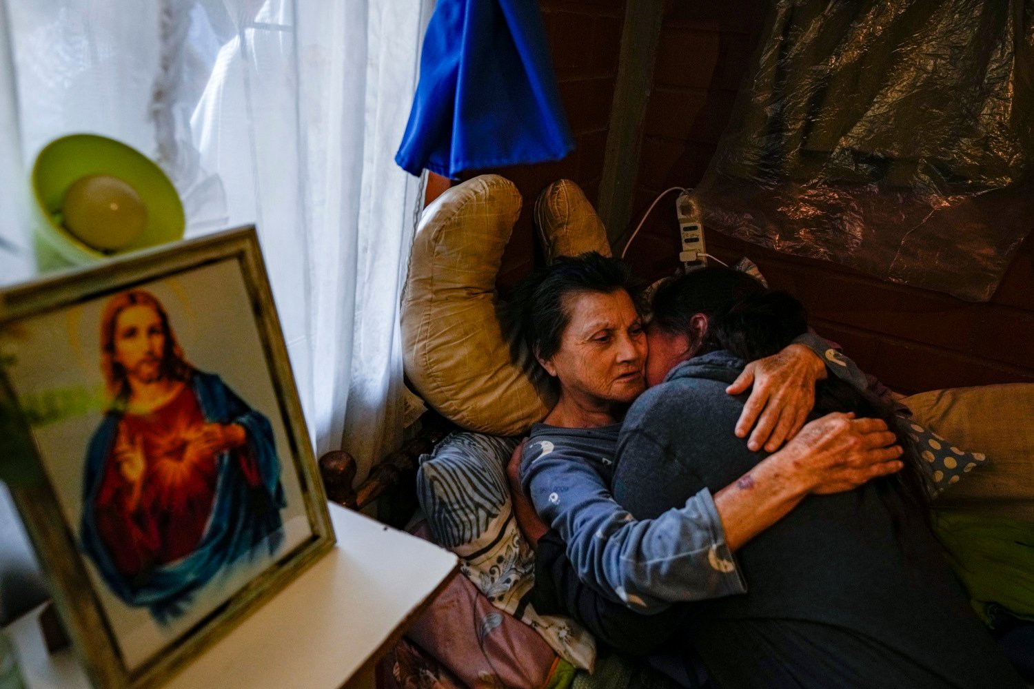  A woman embraces a relative after receiving a blessing from a priest inside her house during the Quasimodo Feast, a celebration held on the first Sunday after Easter, in Colina, Chile, April 7, 2024. The "Huasos" accompany priests to give communion 