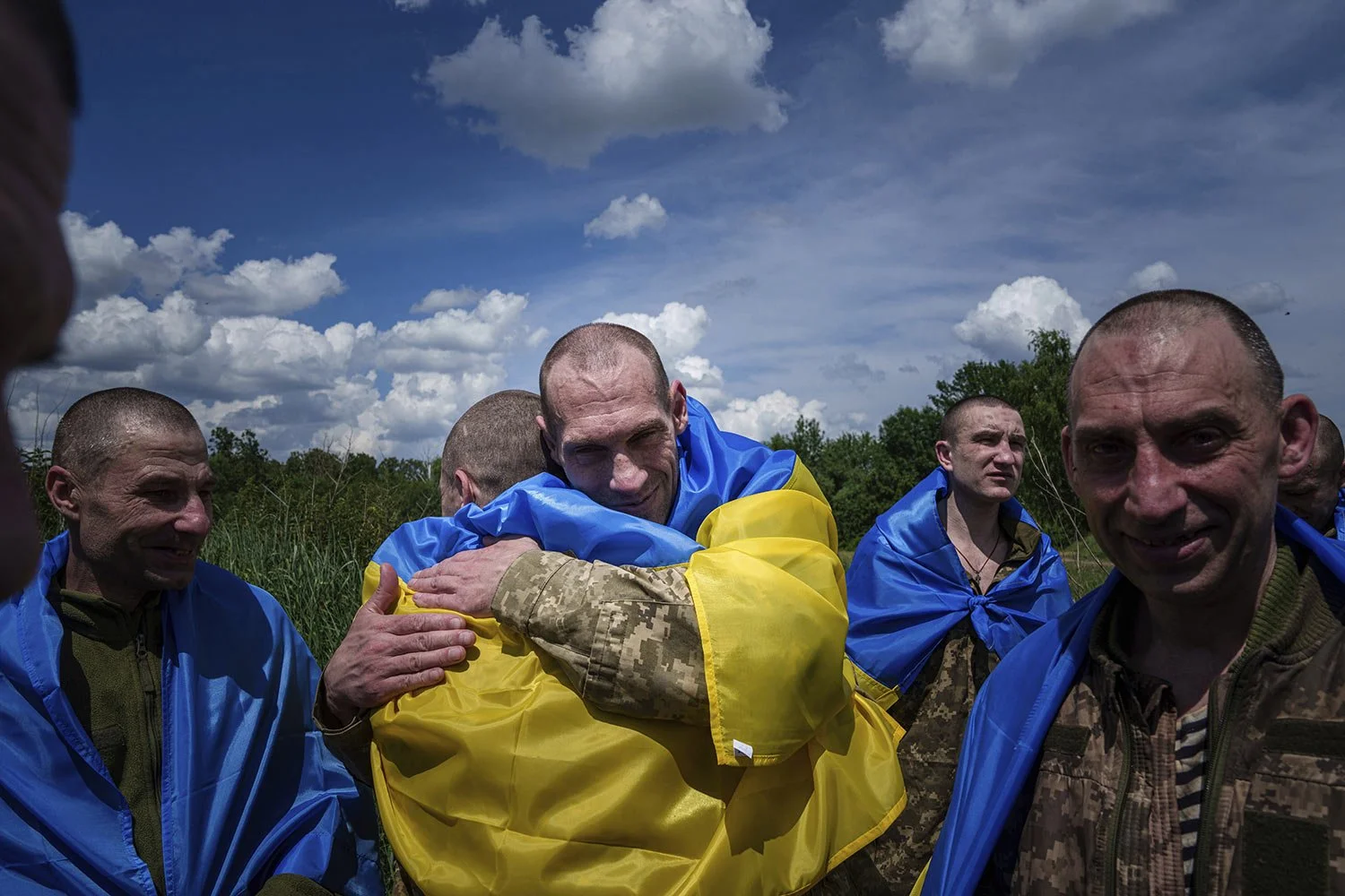  A Ukrainian serviceman hugs his comrade after returning from captivity during a POWs exchange in Sumy region, Ukraine, Friday, May 31, 2024. (AP Photo/Evgeniy Maloletka) 