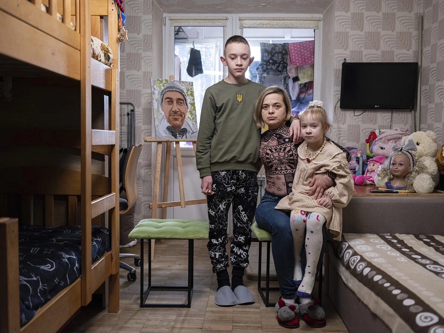  Natalia Sheleshei, 39, with her children Yehor, 12, and Anastasia, 5, wait for the return of Serhii at their apartment in Kyiv, Ukraine on Feb. 12, 2024. (AP Photo/Evgeniy Maloletka) 