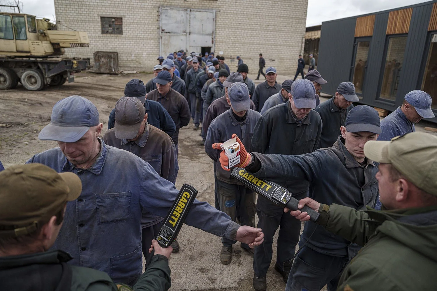  Security guards search captured Russian soldiers with a metal detector at the prisoner of war detention center in Ukraine's Lviv region, Thursday, April 25, 2024. (AP Photo/Evgeniy Maloletka) 