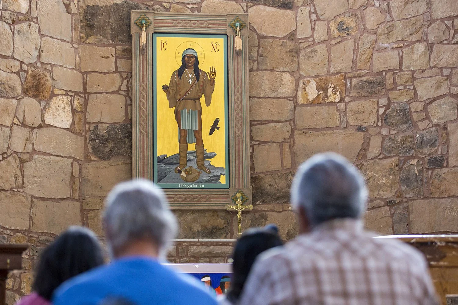  The Apache Christ painting hangs behind the altar of St. Joseph Apache Mission church in Mescalero, New Mexico, Saturday, July 13, 2024. The painting, an icon that depicts Christ as a Mescalero medicine man, was the forefront of a tension-filled epi