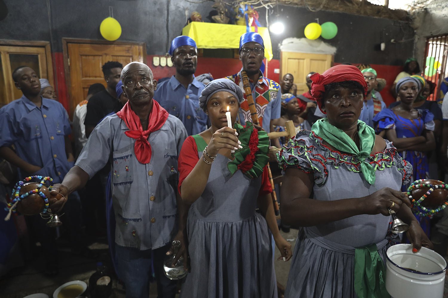  Vodou pilgrims attend a Mass marking the feast day of agriculture and work, in Port-au-Prince, Haiti, Wednesday, May 1, 2024. Amid the spiraling chaos, a growing number of Haitians are praying more or visiting Vodou priests known as "oungans" for ur