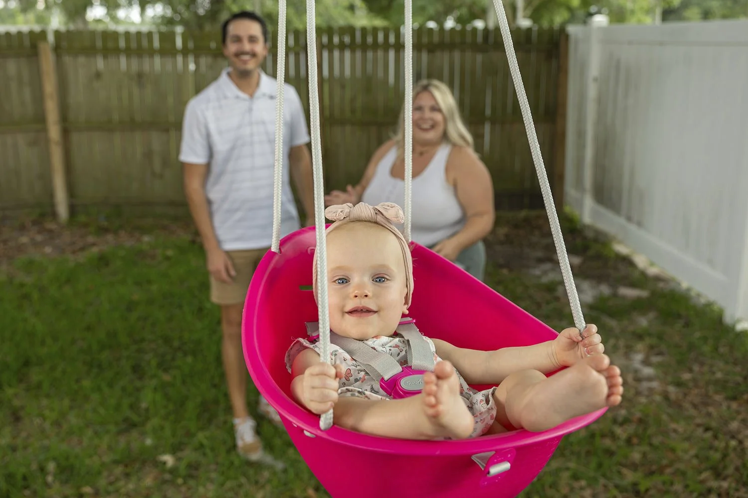  Sam Earle, left, and his wife, Tori, watch their daughter, Novalie, swing in their backyard Tuesday, May 7, 2024, in Lakeland, Fla. Novalie was born through an embryo adoption.  (AP Photo/Mike Carlson) 