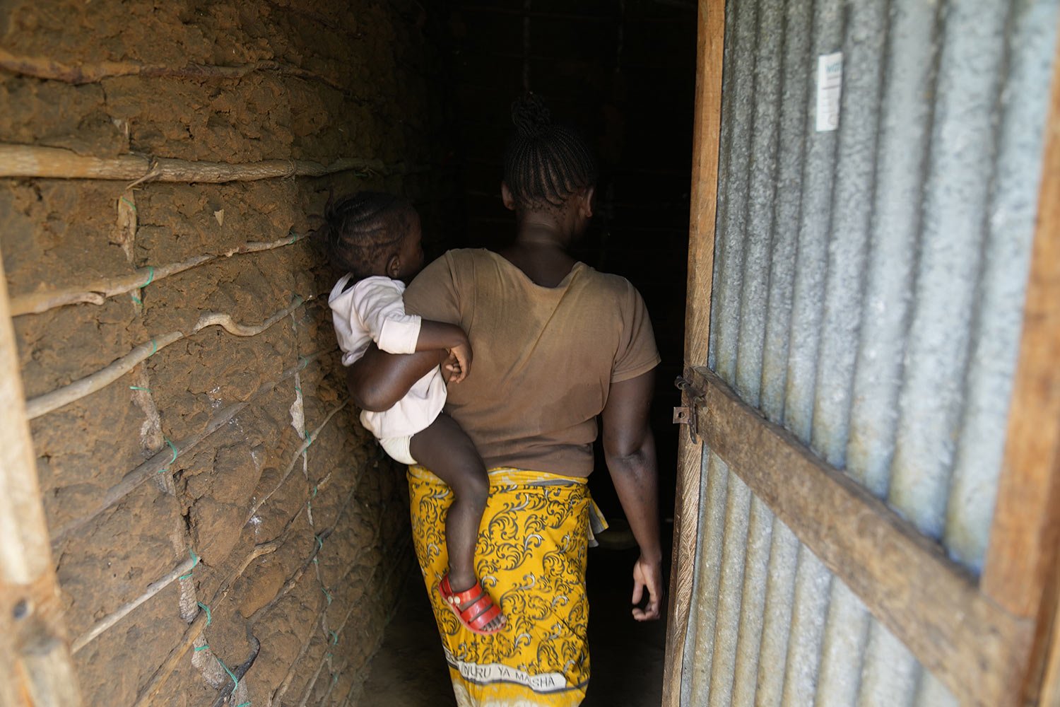  A woman who escaped the Good News International Church in Shakahola after she said she was sexually assaulted, enters a house in the coastal city of Malindi, in southern Kenya, on Friday, Sept. 6, 2024. (AP Photo/Brian Inganga) 