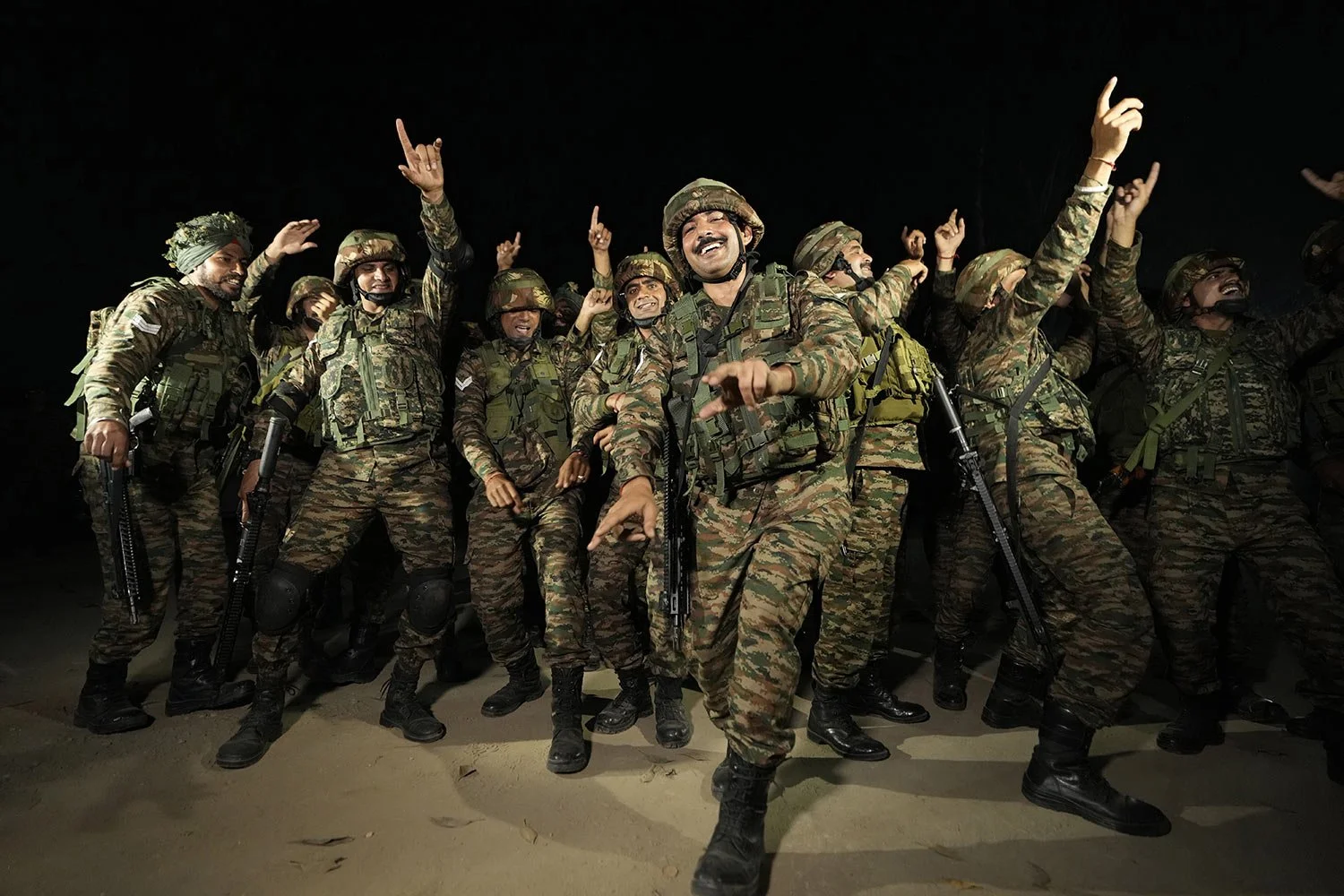  Indian army soldiers dance to celebrate Diwali near the Line of Control that divides Kashmir region between India and Pakistan, in Akhnoor sector, about 66 kilometers (41 miles) from Jammu, India, Monday, Oct. 28, 2024. (AP Photo/Channi Anand) 