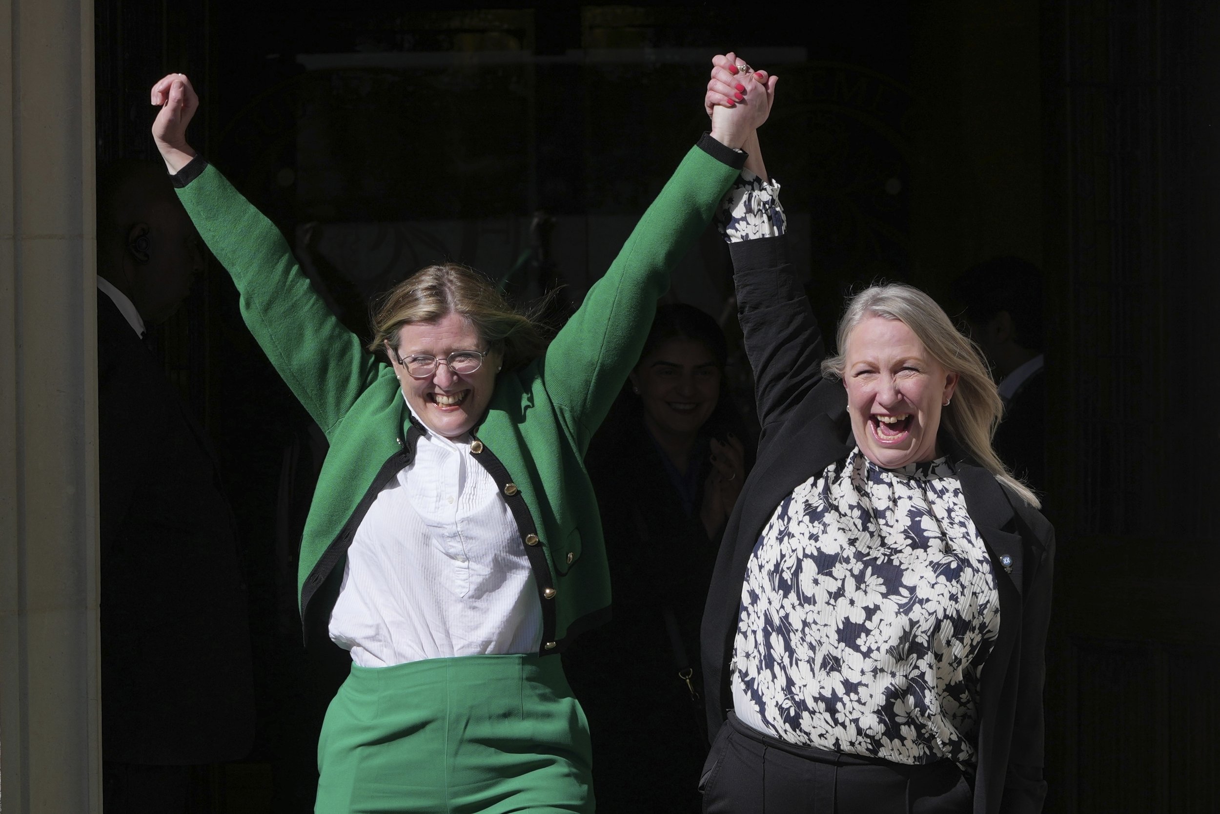 Marion Calder, right, and Susan Smith, left, from For Women Scotland, celebrate outside after the U.K. Supreme Court ruled that a woman is someone born biologically female, excluding transgender people from the legal definition in a long-running dis