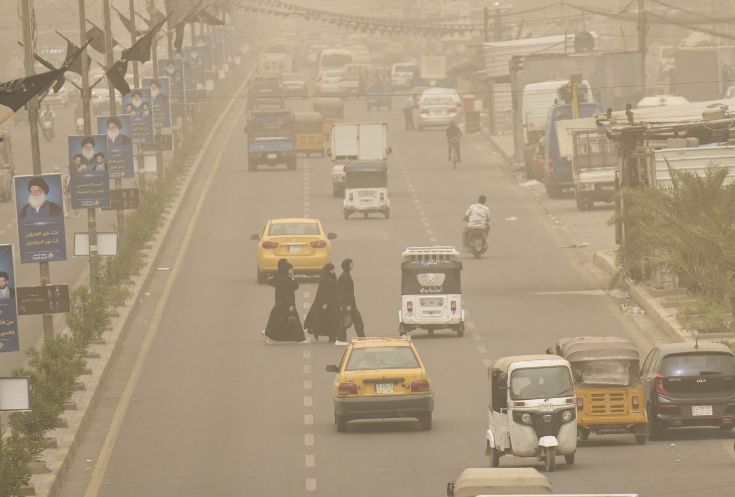 Iraqis walk through the streets during a heavy sandstorm in Baghdad, Iraq, Sunday, May 4, 2025. (AP Photo/Hadi Mizban)