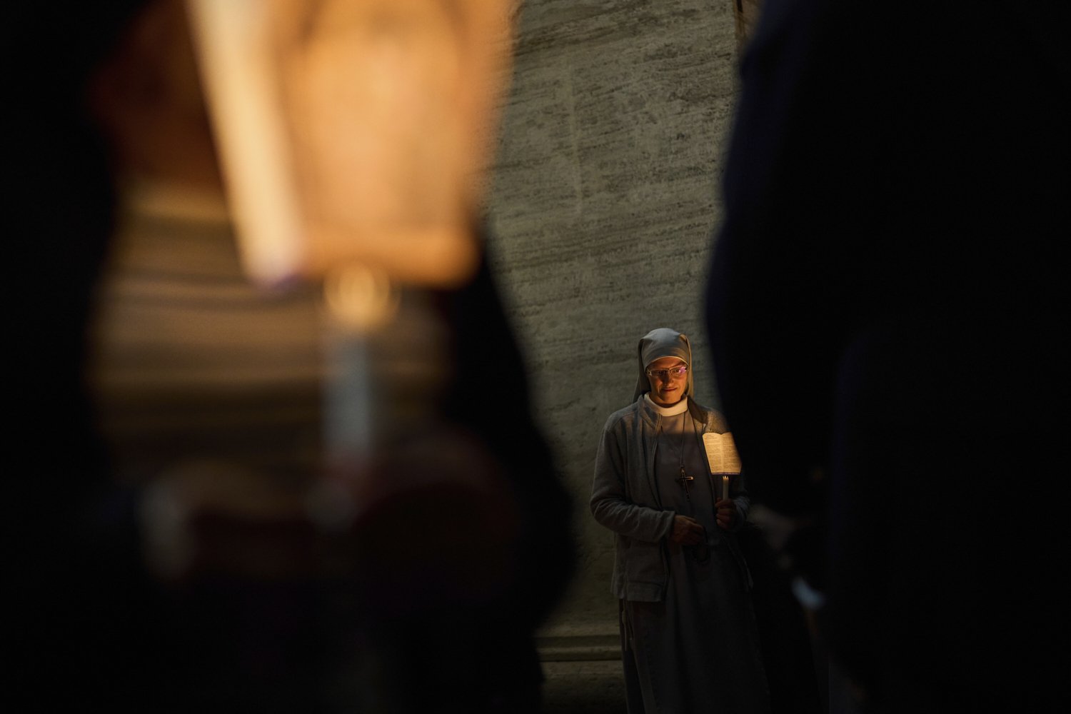 A Catholic nun attends rosary prayer and a candlelight procession with the image of Mater Ecclesiae in St. Peter's Square at the Vatican,Saturday, May 3, 2025. (AP Photo/Bernat Armangue)