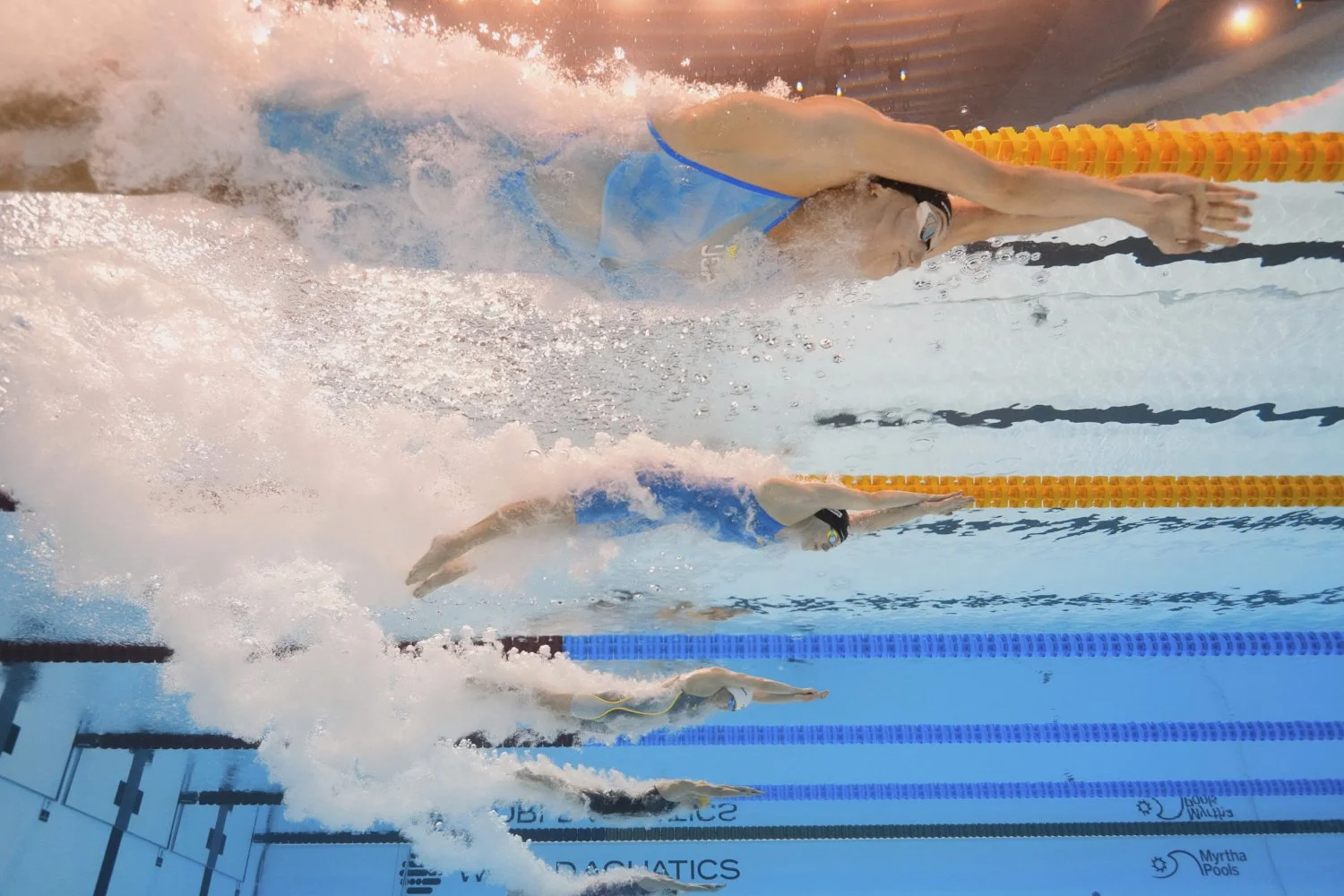 Gretchen Walsh of the United States, top, and Roos Vanotterdijk of Belgium, second from top, compete in the women's 100-meter butterfly semifinal at the World Aquatics Championships in Singapore, Sunday, July 27, 2025. (AP Photo/Lee Jin-man)