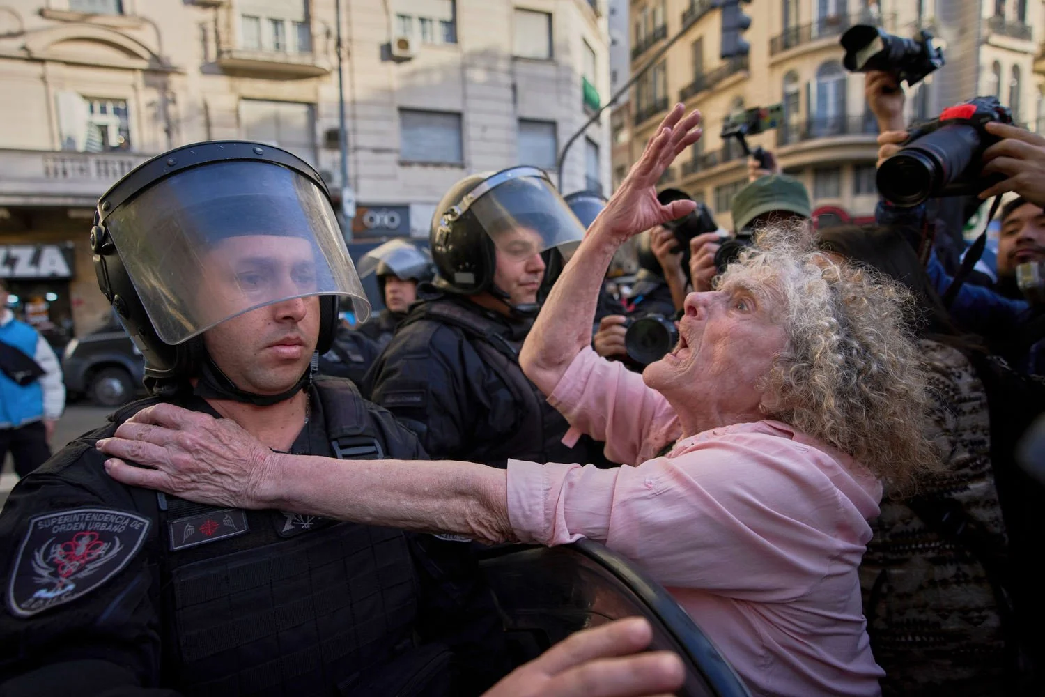Delia Donn, 78, attends a weekly protests demanding better pensions for retirees as police stand guard near Congress in Buenos Aires, Argentina, July 30, 2025. (AP Photo/Rodrigo Abd)