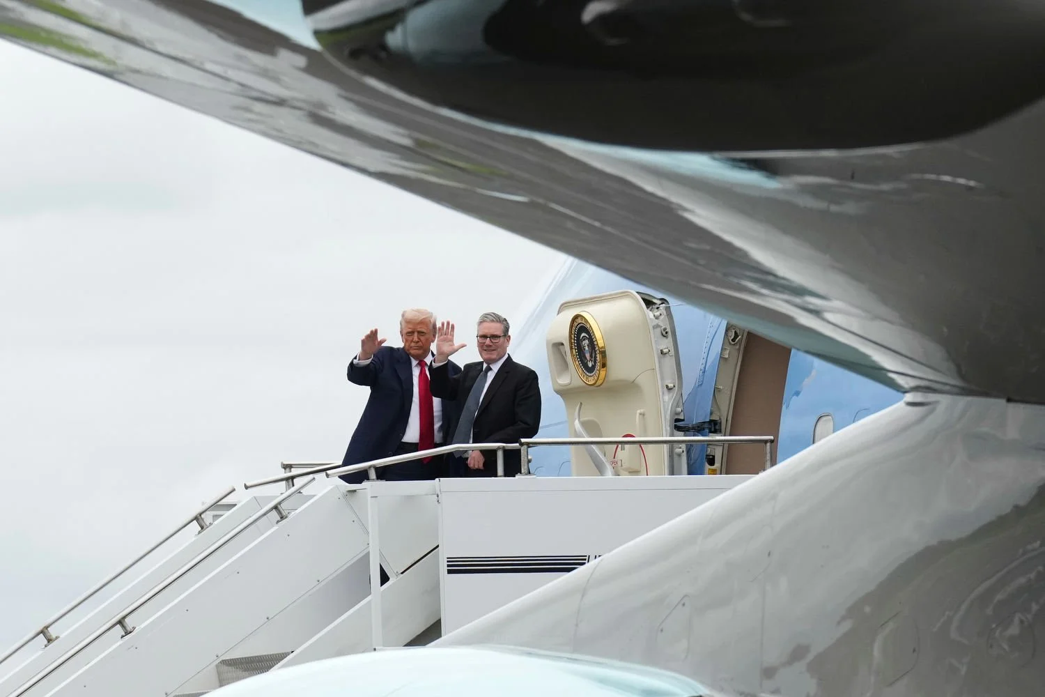 U.S. President Donald Trump, left, and Britain's Prime Minister Keir Starmer wave before boarding Air Force One at Prestwick Airport in Ayrshire, Scotland, July 28, 2025. (AP Photo/Jacquelyn Martin)