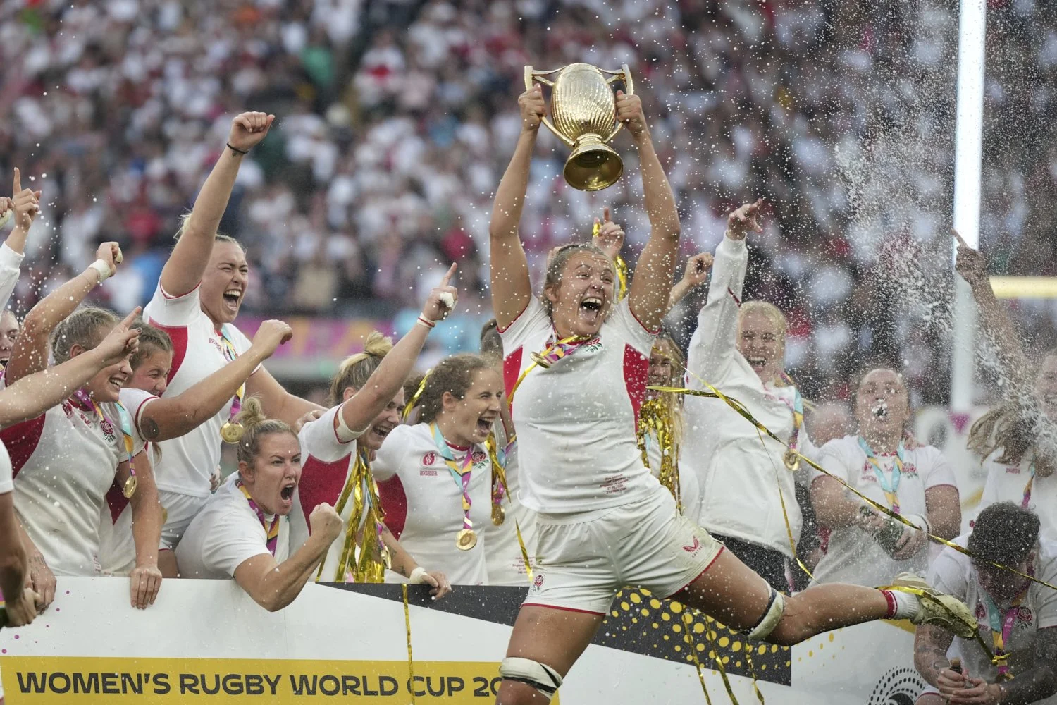 England's Zoe Aldcroft holds a trophy as she celebrates with her teammates after winning the Women's Rugby World Cup final match between England and Canada at the Allianz Stadium, Twickenham, London, Saturday, Sept. 27, 2025. (AP Photo/Alastair Gran