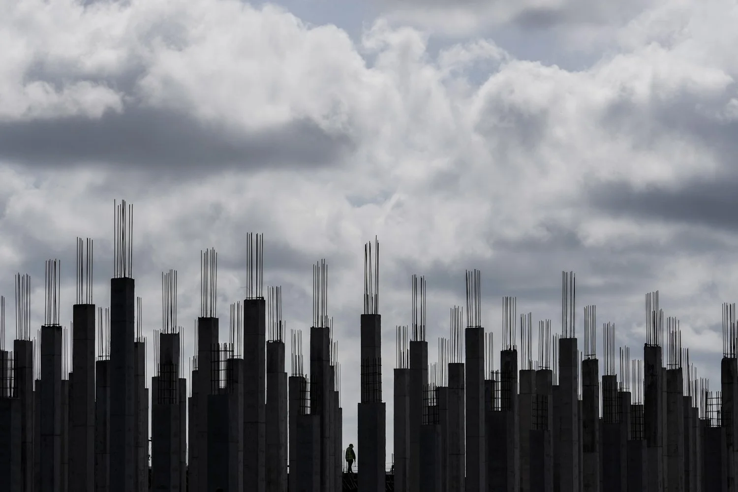 A worker walks through a building under construction in Georgetown, Guyana, Tuesday, Sept. 2, 2025. (AP Photo/Matias Delacroix)