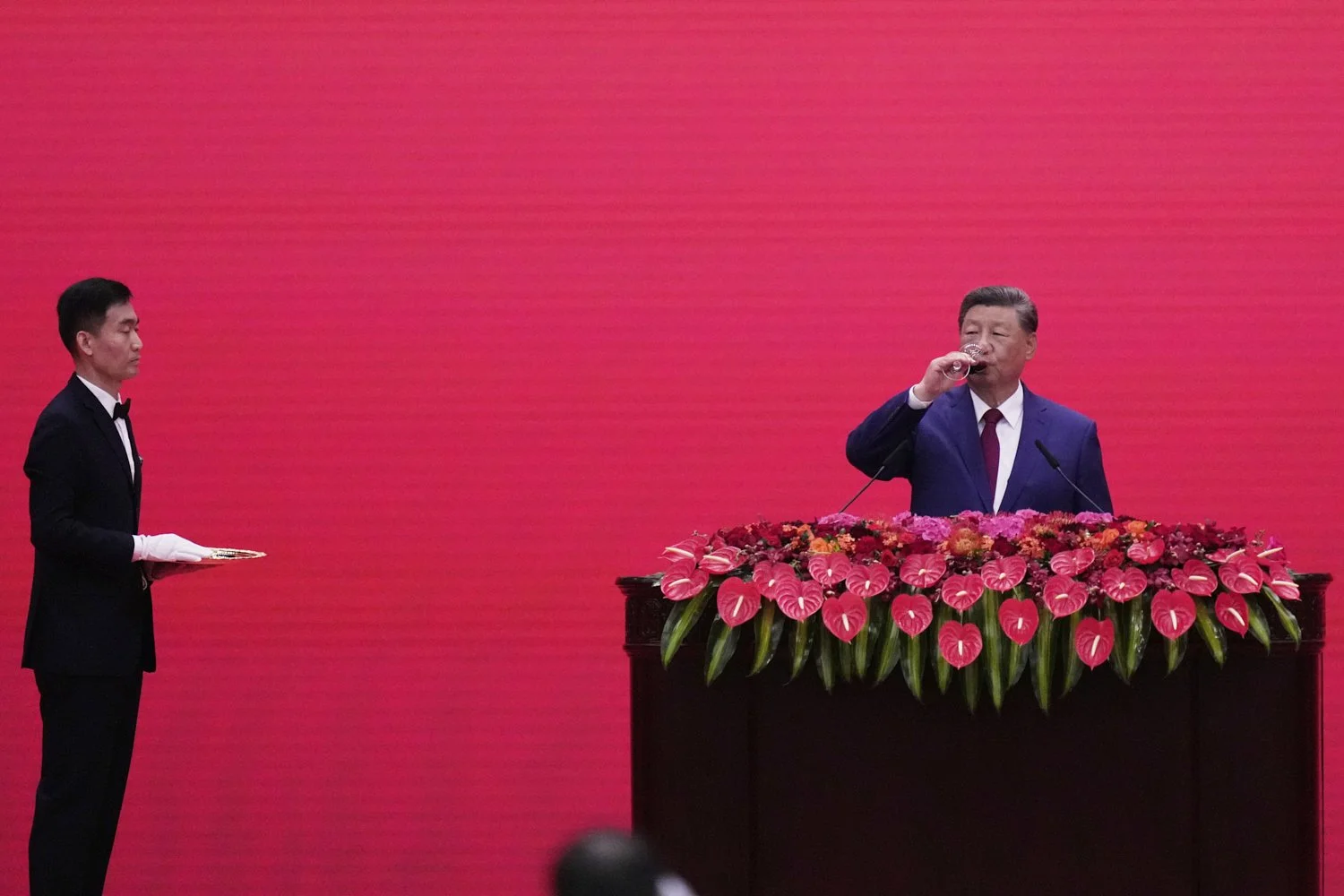 Chinese President Xi Jinping takes a drink at a reception following a military parade to commemorate the 80th anniversary of Japan's World War II surrender held in front of Tiananmen Gate in Beijing, Wednesday, Sept. 3, 2025. (AP Photo/Mahesh Kumar)