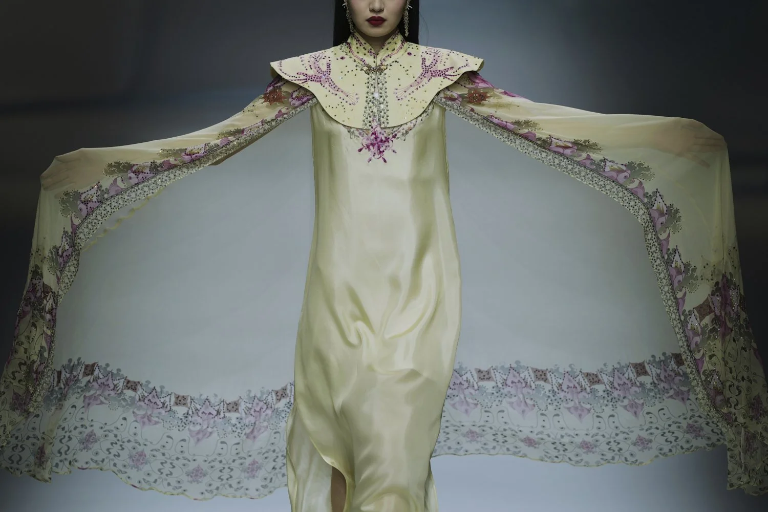 A model showcases a creation from the RU ZI ZHI YI collection by Yue Min during the SS2026 China Fashion Week, in Beijing, China, Thursday, Sept. 11, 2025. (AP Photo/Andy Wong)