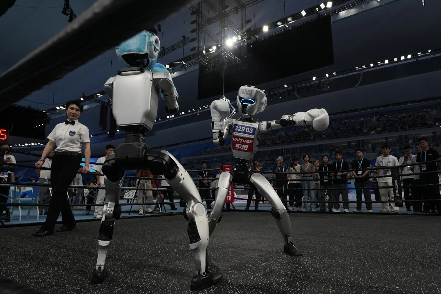 Robots compete at the Free Combat event of the World Humanoid Robot Games in Beijing, China, Aug. 15, 2025. (AP Photo/Ng Han Guan)
