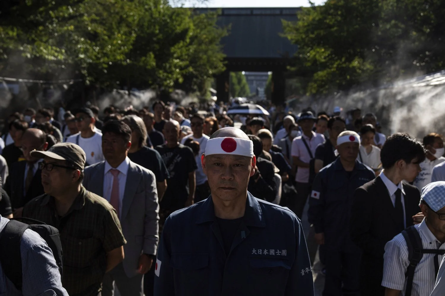 Visitors line up to offer prayers at the Yasukuni Shrine on the 80th anniversary of Japan's surrender in World War II in Tokyo, Aug. 15, 2025. (AP Photo/Louise Delmotte)