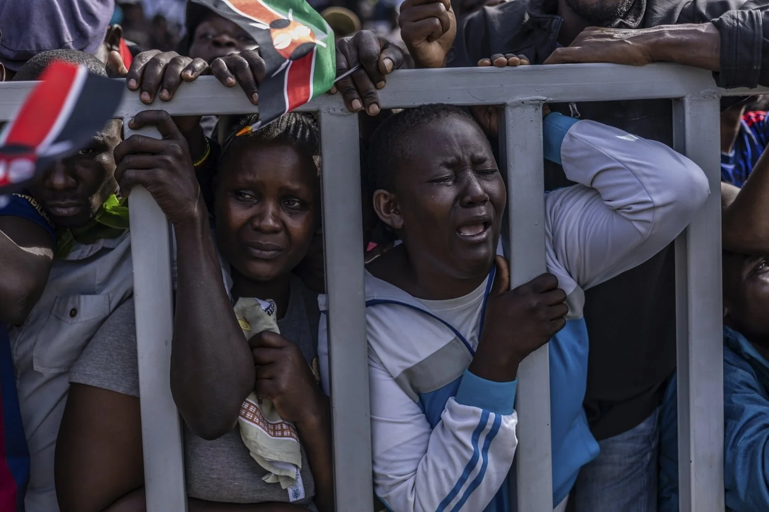  People react during the viewing of the body of former Kenya Prime Minister Raila Odinga at Jomo Kenyatta Stadium in Kisumu, Kenya, Oct. 18, 2025. (AP Photo/Samson Otieno) 