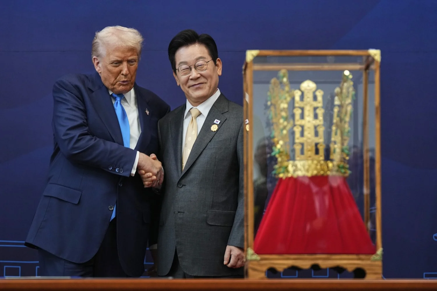  President Donald Trump shakes hands with South Korean President Lee Jae Myung as he receives a gift of a gold crown and an award of the Grand Order of Mugunghwa, not seen, during a high honor ceremony at the Gyeongju National Museum in Gyeongju, Sou