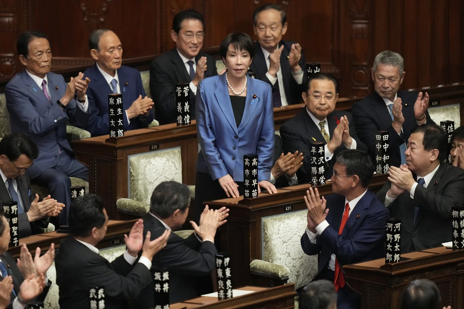  Lawmakers applaud as Sanae Takaichi, center, is elected as Japan's new prime minister during the extraordinary session of the lower house, in Tokyo, Japan, Oct. 21, 2025. (AP Photo/Eugene Hoshiko) 