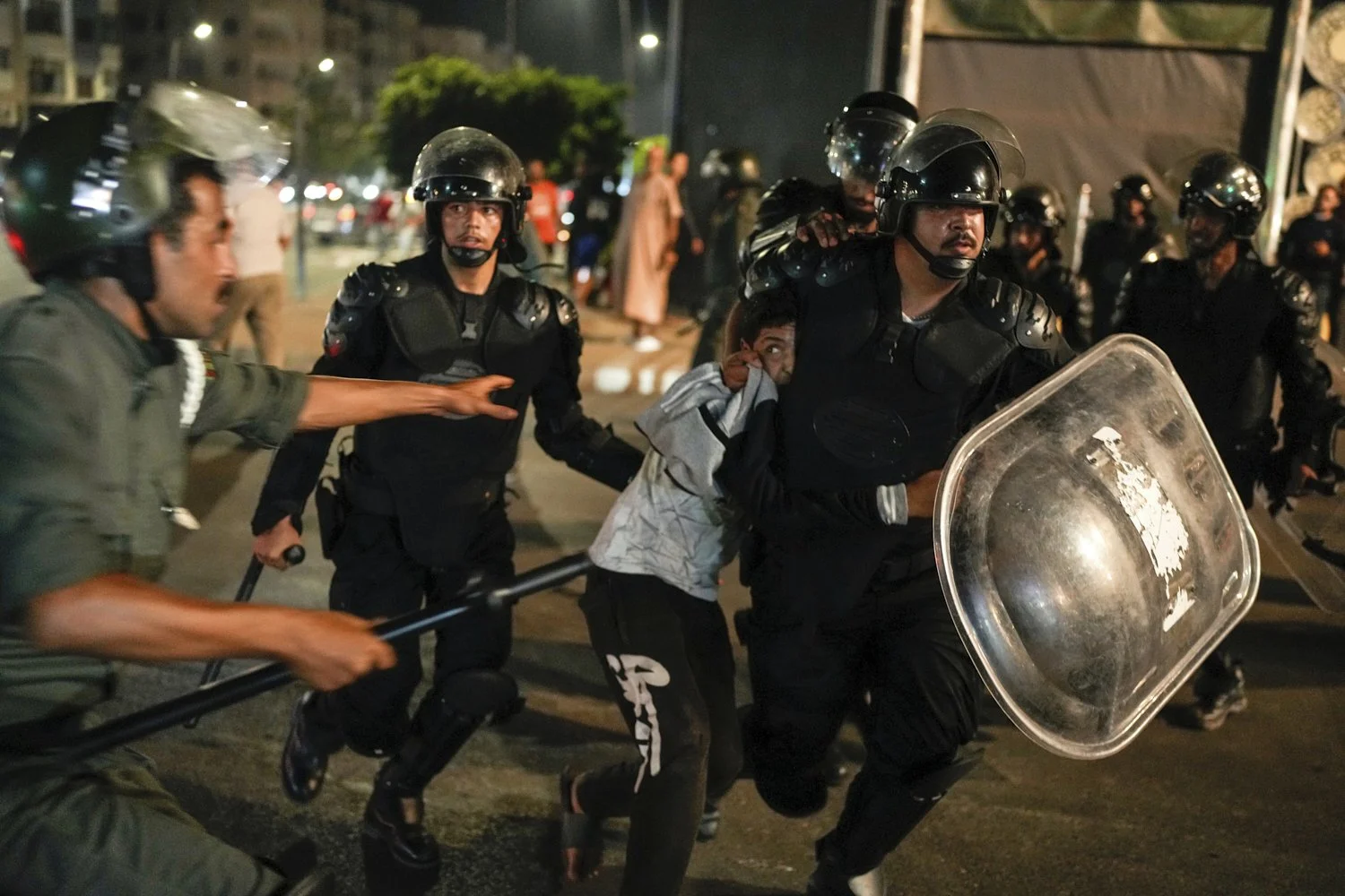  A boy is detained as youth led protests calling for healthcare and education reforms turned violent, in Sale, Morocco, Oct. 1, 2025. (AP Photo/Mosa'ab Elshamy) 