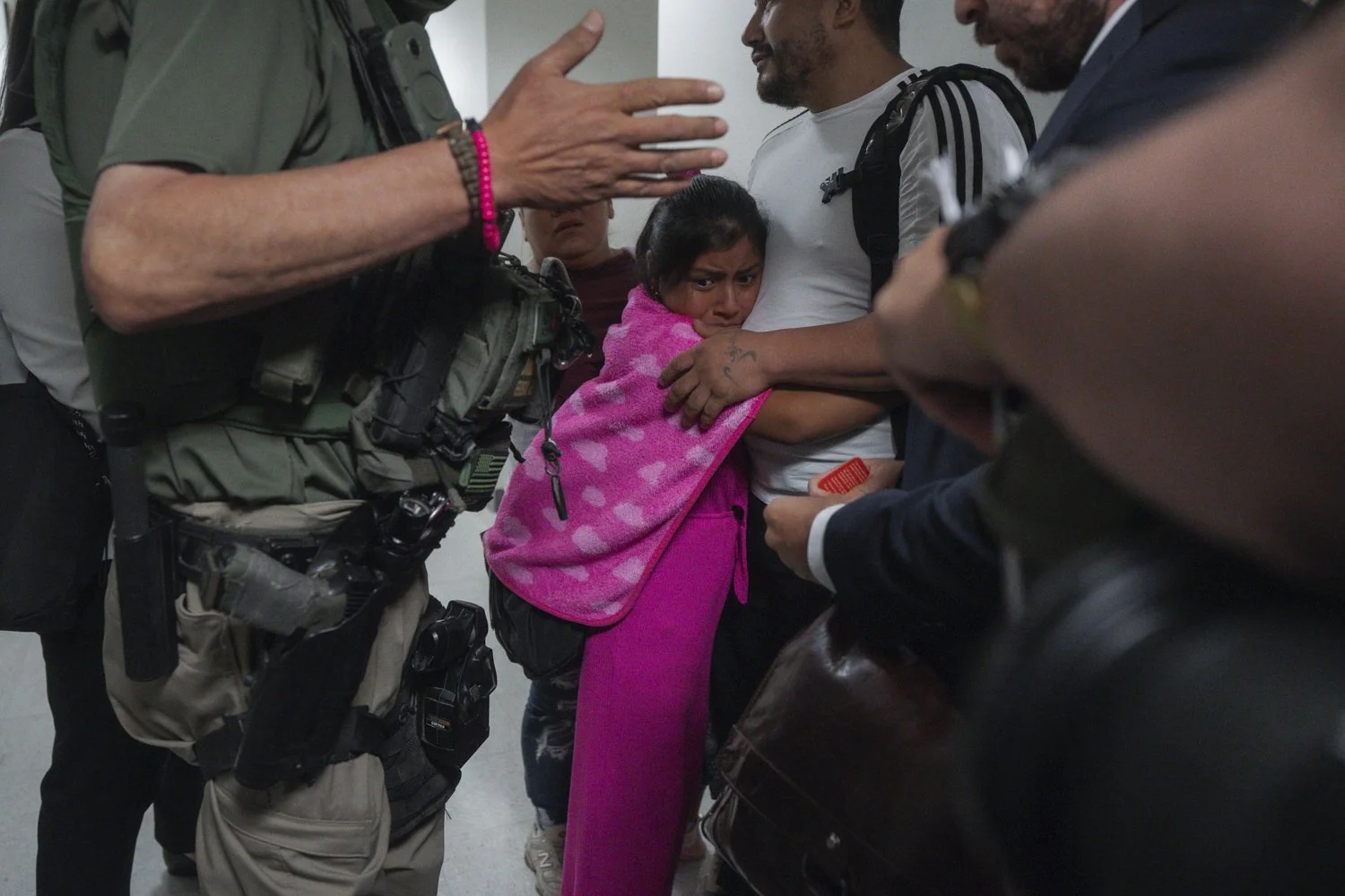  An asylum seeker from Ecuador hugs her father as he is detained by federal agents on Thurs., July 31, 2025 (AP Photo/Olga Fedorova) 