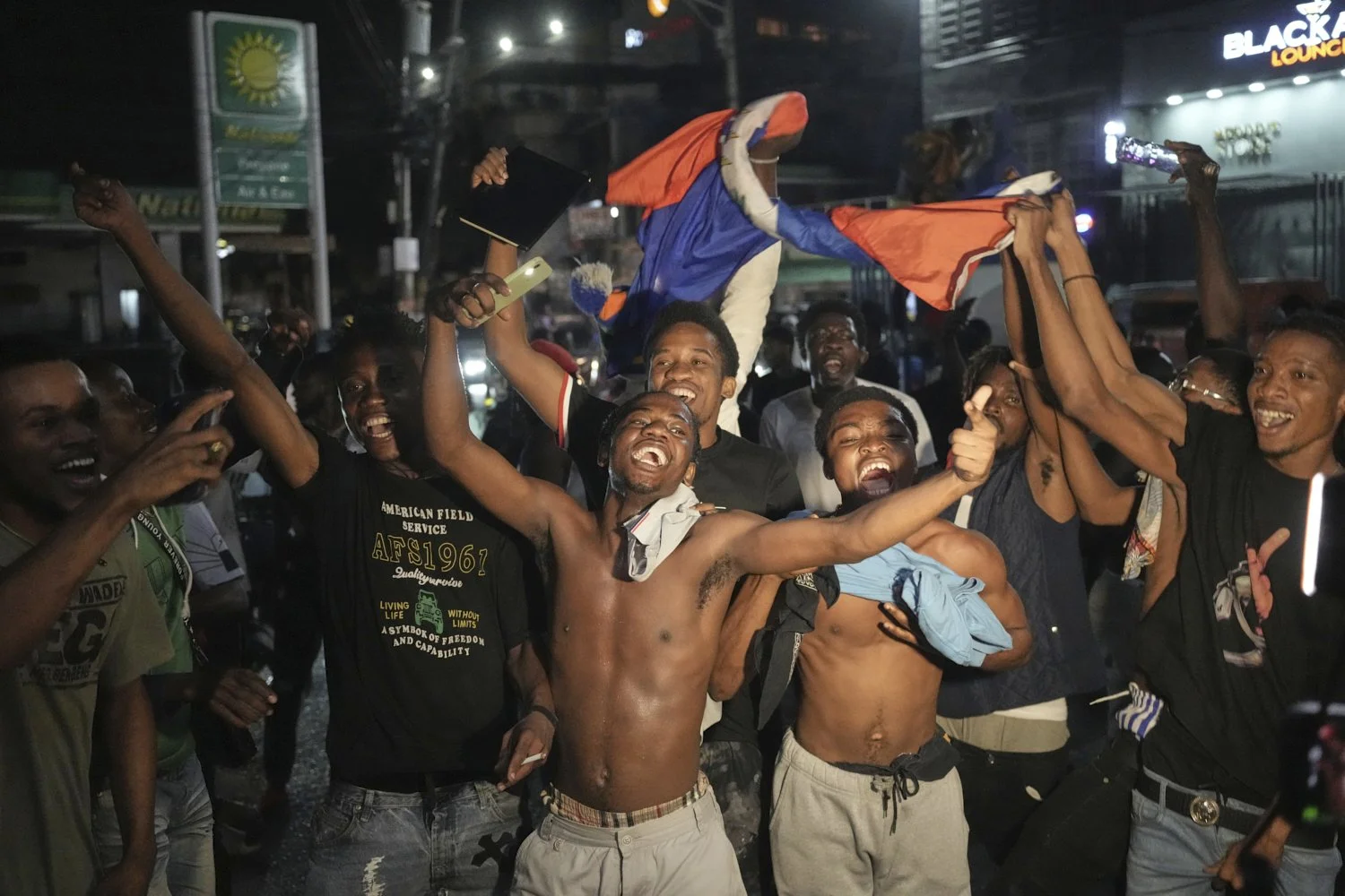  Fans celebrate Haiti's qualification for the 2026 FIFA World Cup after a soccer match against Nicaragua, in Port-au-Prince, Haiti, Tuesday, Nov. 18, 2025. (AP Photo/Odelyn Joseph) 
