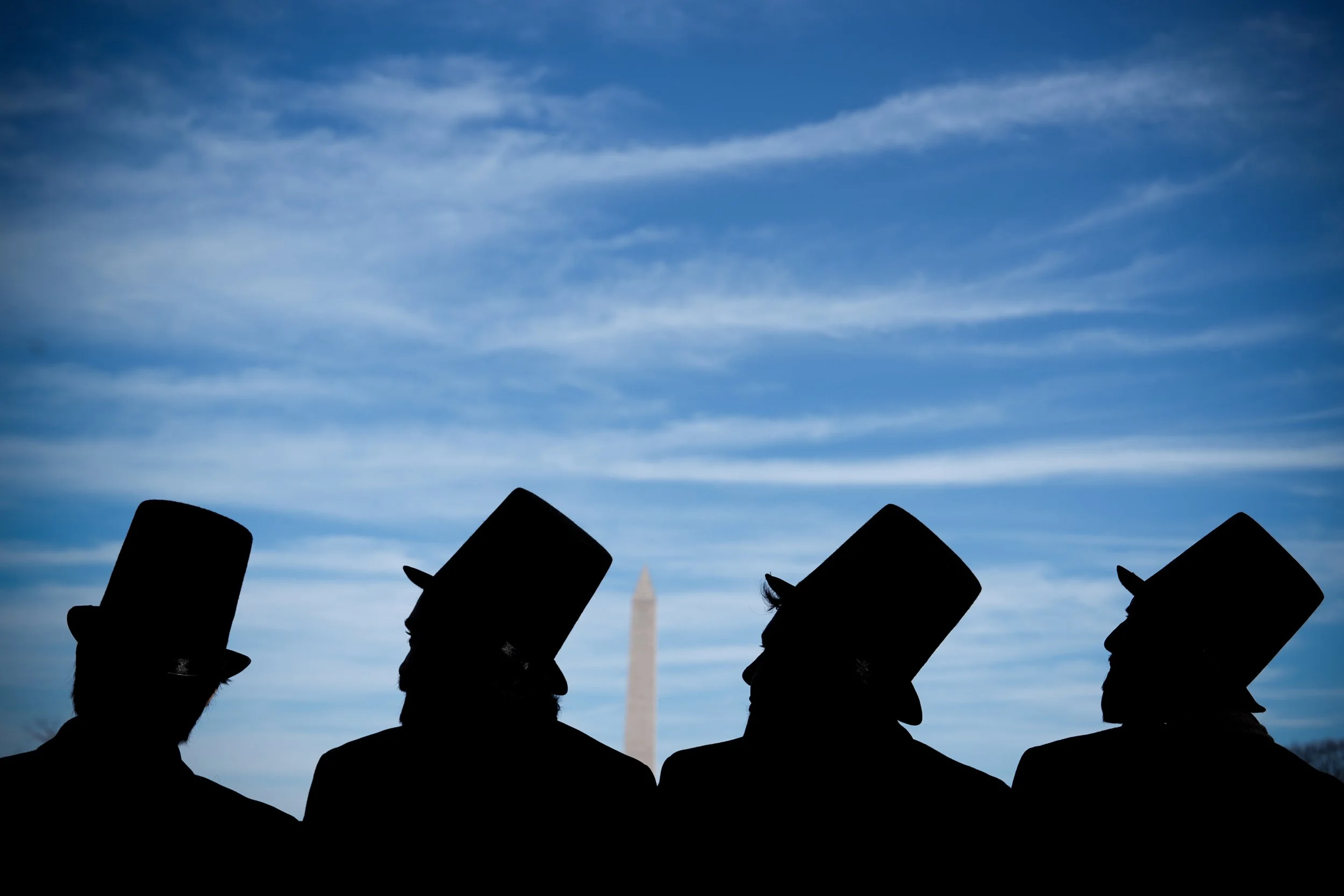  Men dressed as former President Abraham Lincoln attend a mock funeral for the penny, which was discontinued earlier in the year, in front of the Lincoln Memorial in Washington, Dec. 20, 2025. (AP Photo/Julia Demaree Nikhinson) 