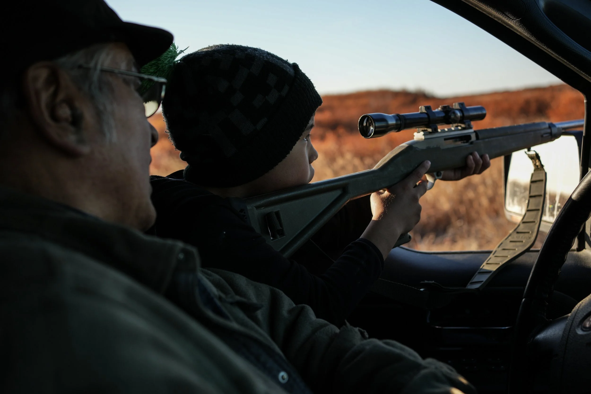  Roswell Schaeffer, an Inupiaq hunter and fisher, helps his 7-year-old great-grandson James Schaeffer scope ducks while hunting in Kotzebue, Alaska, Sept. 26, 2025. (AP Photo/Annika Hammerschlag) 