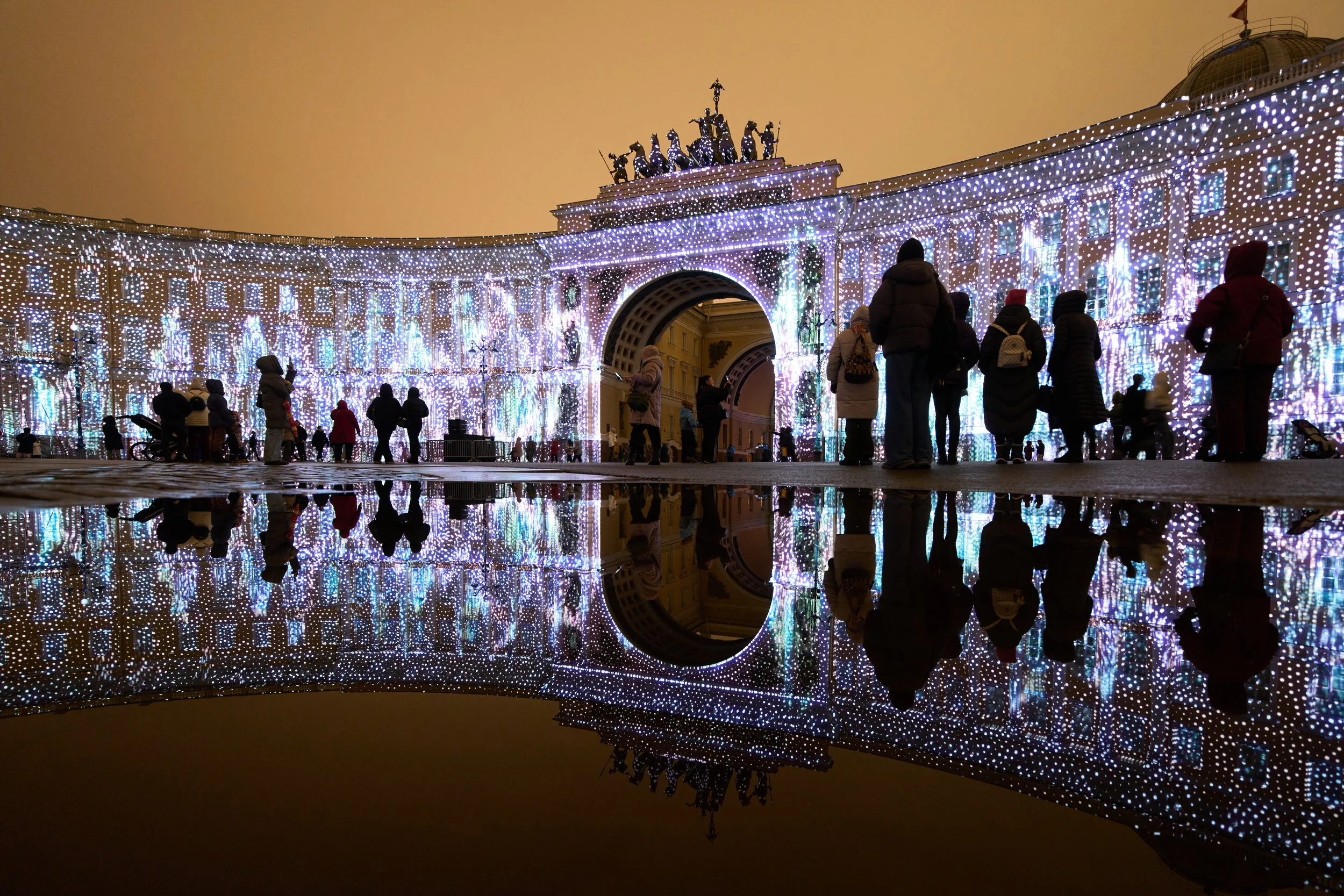  People watch a multimedia light show during the "Country of Light" festival at the Palace Square in St. Petersburg, Russia, Dec. 7, 2025. (AP Photo/Dmitri Lovetsky) 