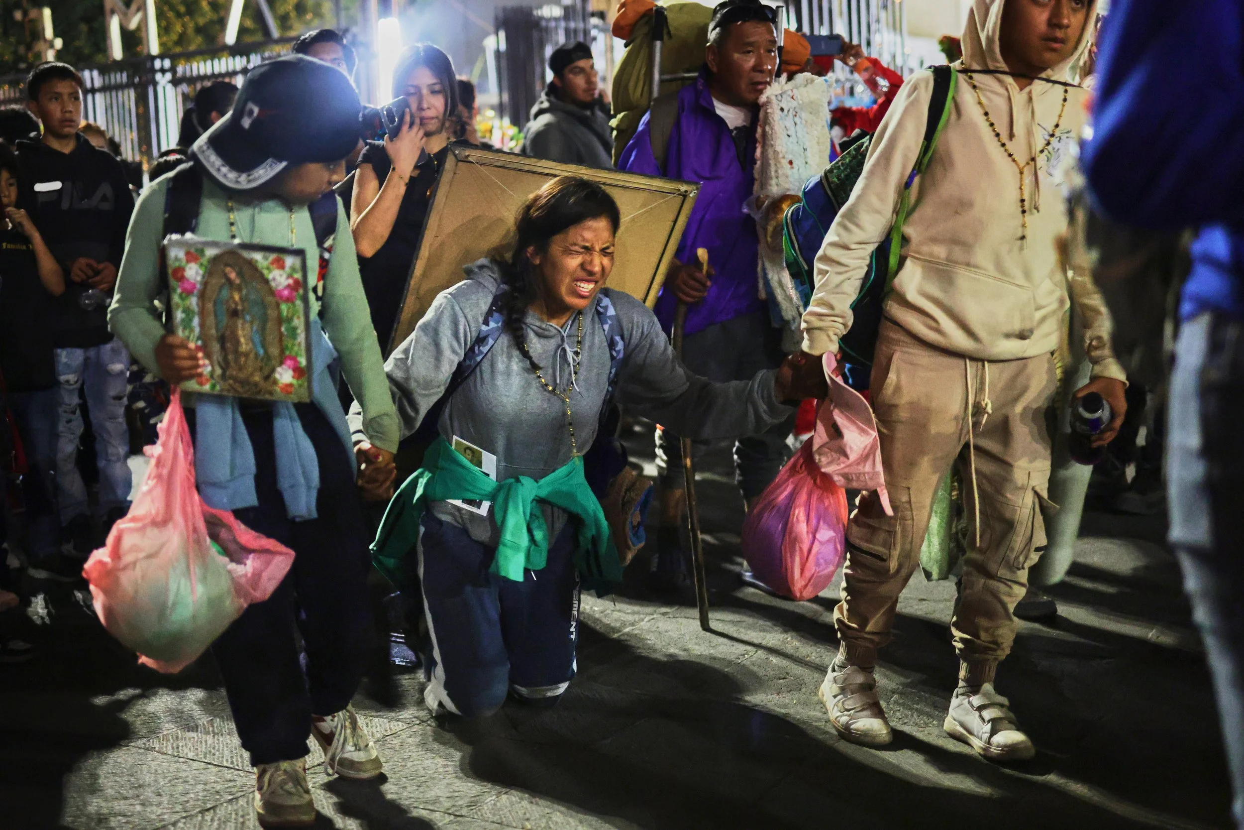 Pilgrims arrive at Our Lady of Guadalupe Basilica in Mexico City, Dec. 11, 2025, the night before her feast day. (AP Photo/Claudia Rosel) 