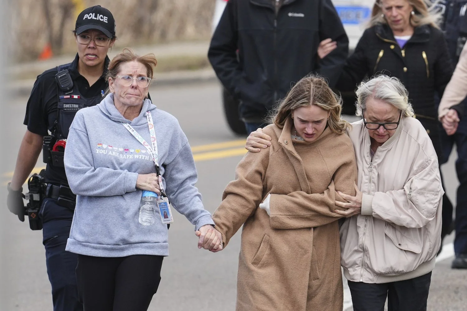 Law enforcement escort families away from the Temple Israel synagogue following an attack, March 12, 2026, in West Bloomfield Township, Mich. (AP Photo/Paul Sancya) 