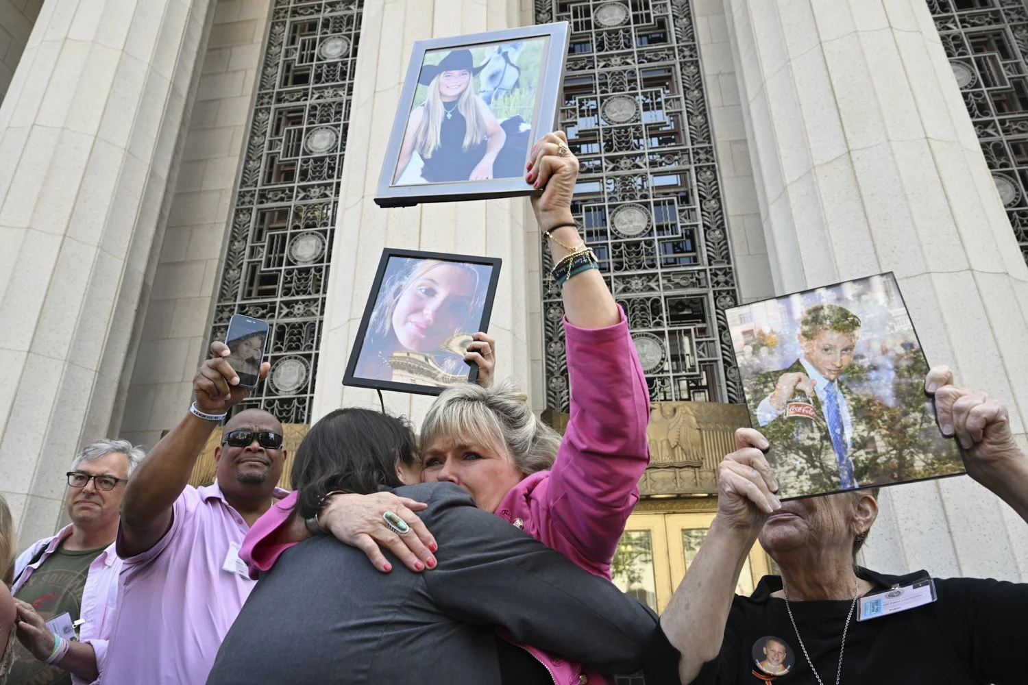  Lori Schott, center, is embraced as she holds up a photo of her daughter, Annalee Schott, after the verdict in a landmark trial over whether social media platforms deliberately addict and harm children at Los Angeles Superior Court, March 25, 2026, 