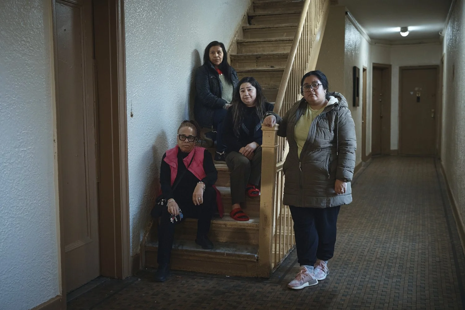  Gulhayo Yuldosheva, 33 , center right, Marina Quiroz, 65, top, pose for a portrait with other two residents in an apartment building where tenants report maintenance issues and pest infestations, in the Bronx borough of New York, Tuesday, March 17, 