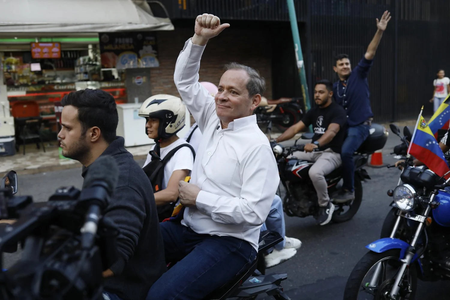  Opposition leader Juan Pablo Guanipa rides on the back of a motorcycle after his release from prison in Caracas, Venezuela, Feb. 8, 2026.(AP Photo/Cristian Hernandez) 