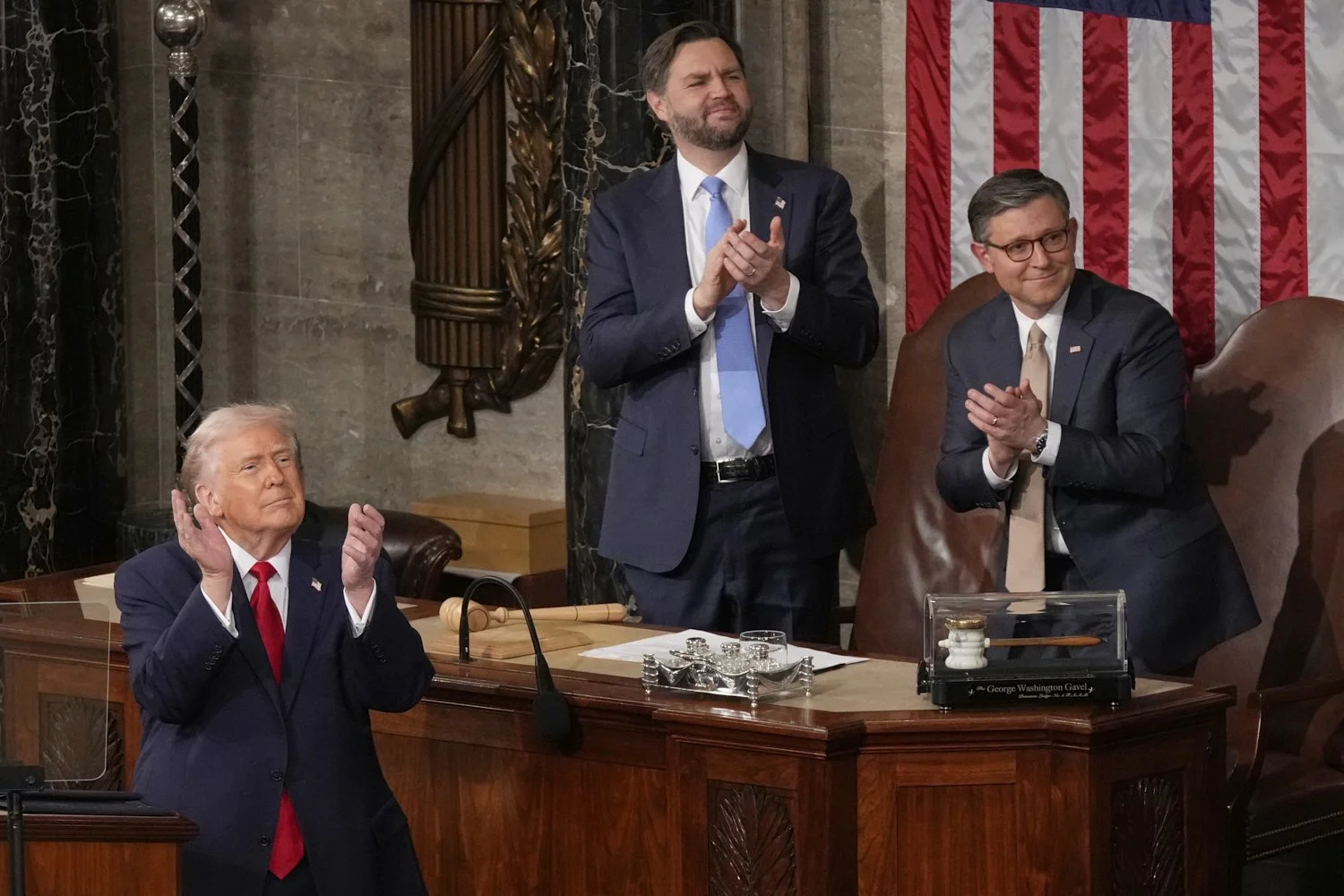  President Donald Trump, Vice President JD Vance and House Speaker Mike Johnson applaud during the State of the Union address in the House chamber at the U.S. Capitol in Washington, Feb. 24, 2026. (AP Photo/Mark Schiefelbein) 