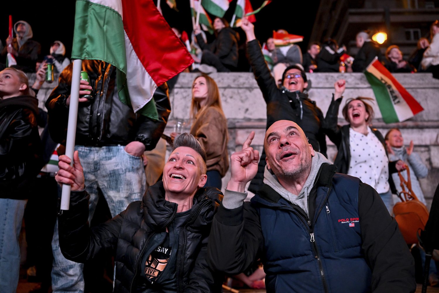  People celebrate after hearing partial results of the parliamentary election, in Budapest, Hungary, April 12, 2026. (AP Photo/Denes Erdos) 