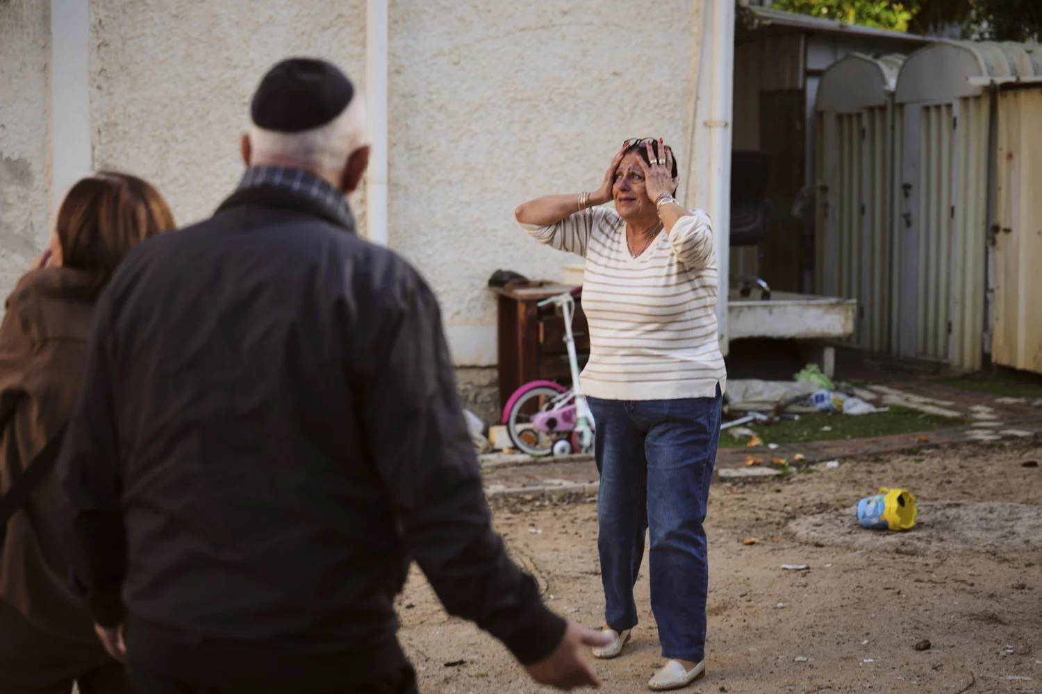  A woman reacts at the site of a damaged residential building after it was struck by a projectile fired from Lebanon, in Nahariya, Israel, April 13, 2026. (AP Photo/Ariel Schalit) 