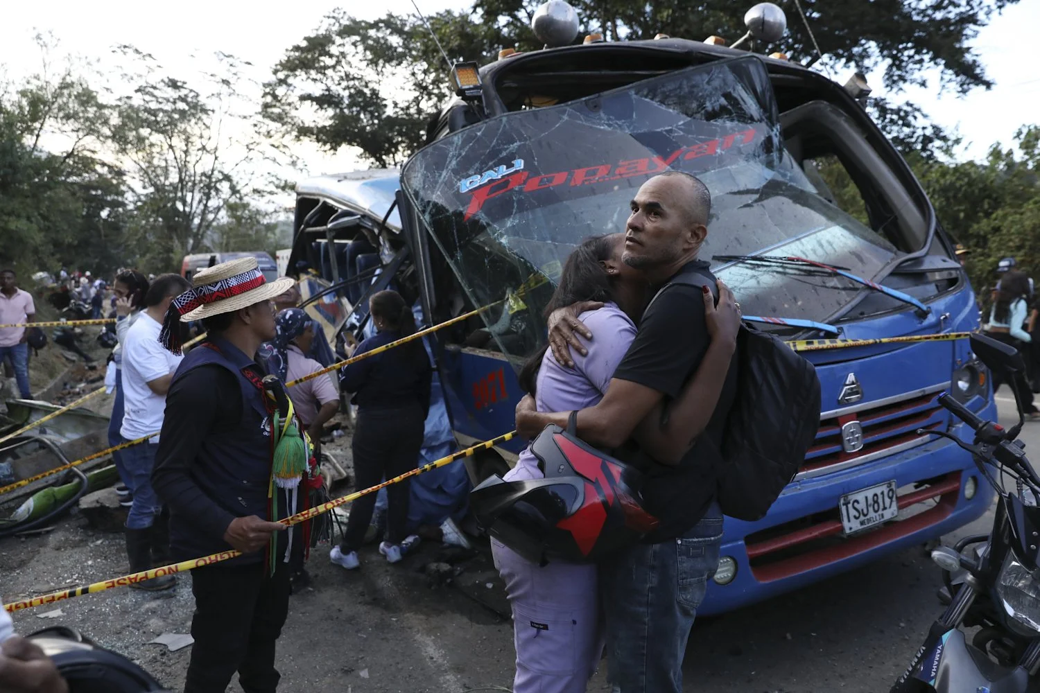 Relatives of victims embrace in front of a bus hit by an explosive device on the Pan-American Highway in Cajibio, Colombia, April 25, 2026, after an attack blamed by authorities on dissident groups of the former FARC rebels killed at least a dozen p