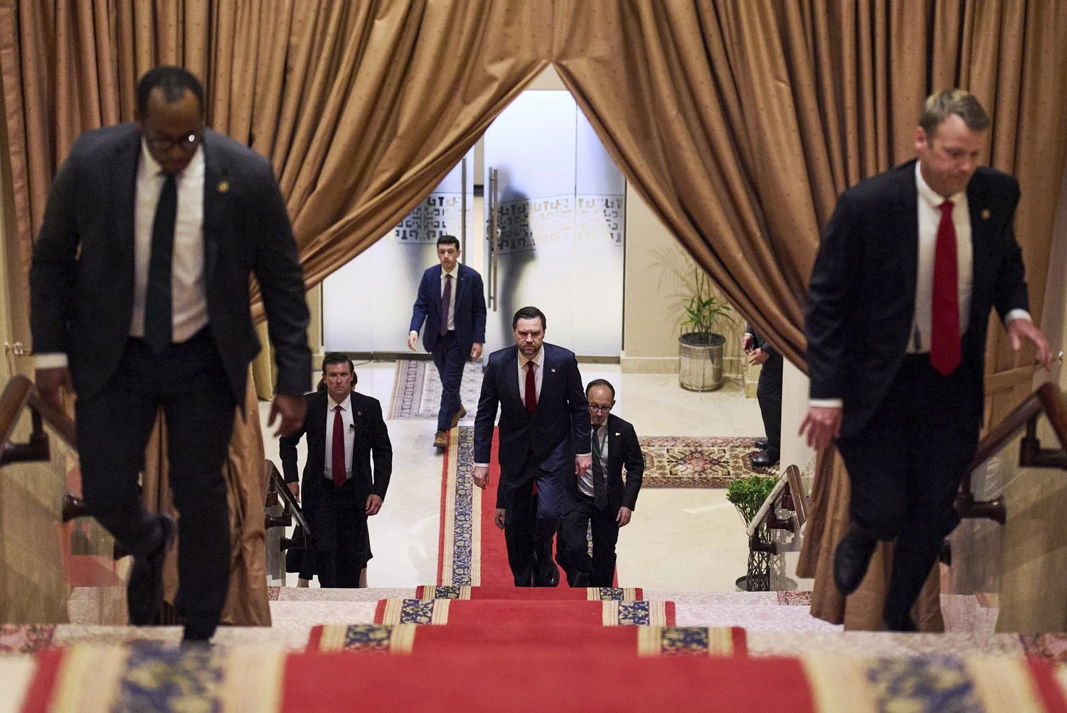  U.S. Vice President JD Vance, center, walks up a flight of stairs to meet with Pakistan's Prime Minister Shehbaz Sharif, in Islamabad, April 11, 2026. (AP Photo/Jacquelyn Martin) 