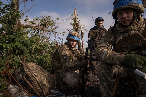 A shell-shocked Ukrainian soldier in a trench is getting taken